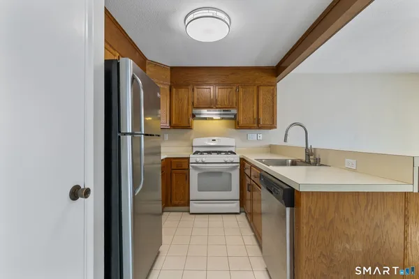 a kitchen with a sink appliances and cabinets