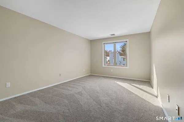 an empty room with windows and closet