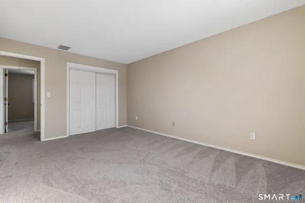 a view of an empty room and closet area