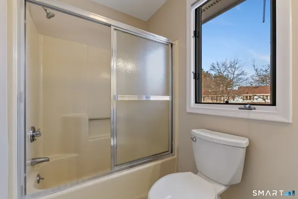 a bathroom with a toilet and a shower