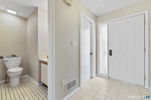 a bathroom with a toilet and a view of bathroom