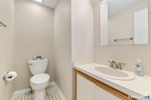 a bathroom with a sink toilet and a mirror