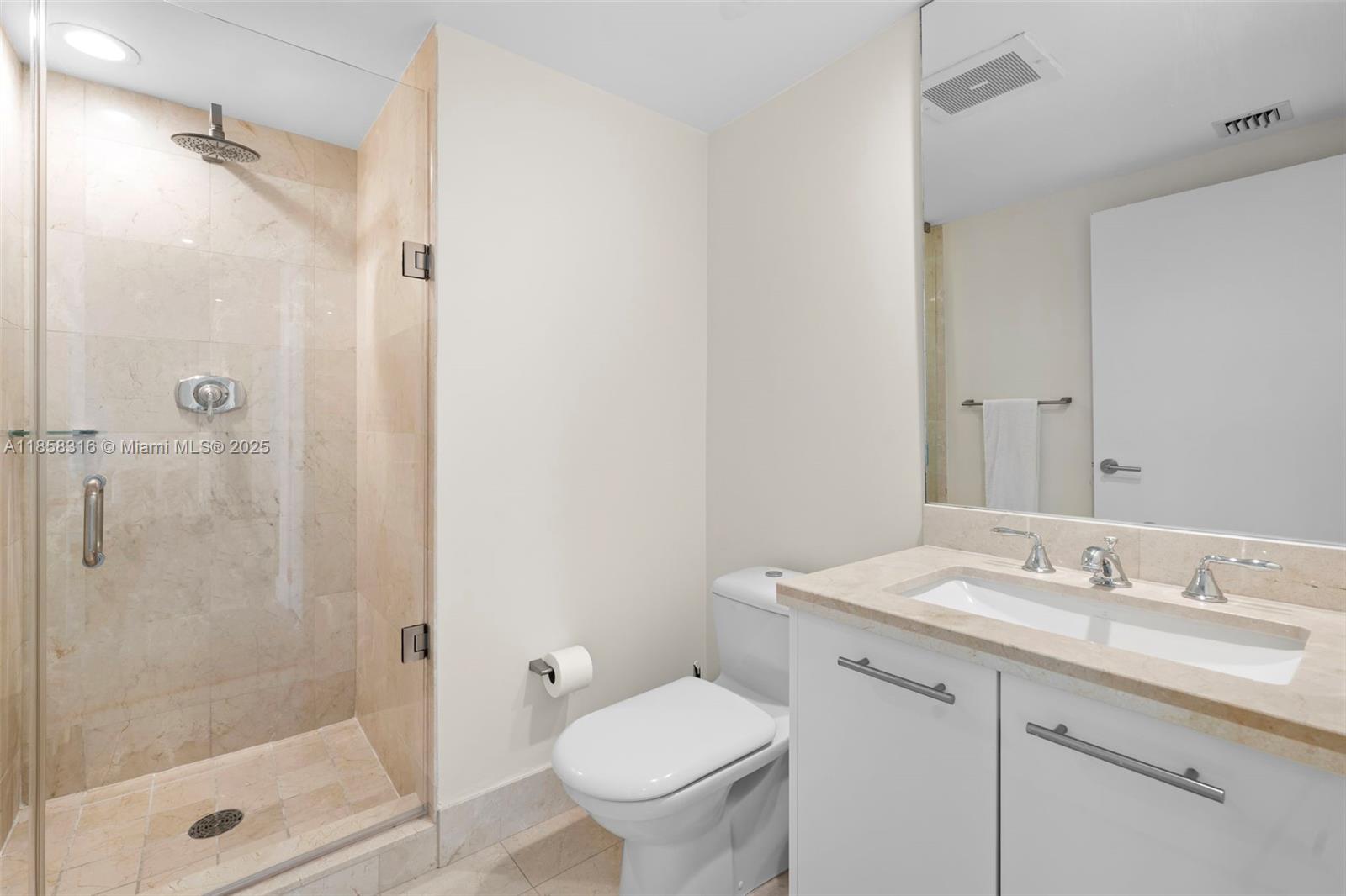 6801 Collins Avenue, Unit DOOR1409 Miami Beach, FL 33141 - Photo 12 of 21 a bathroom with a granite countertop sink toilet and shower