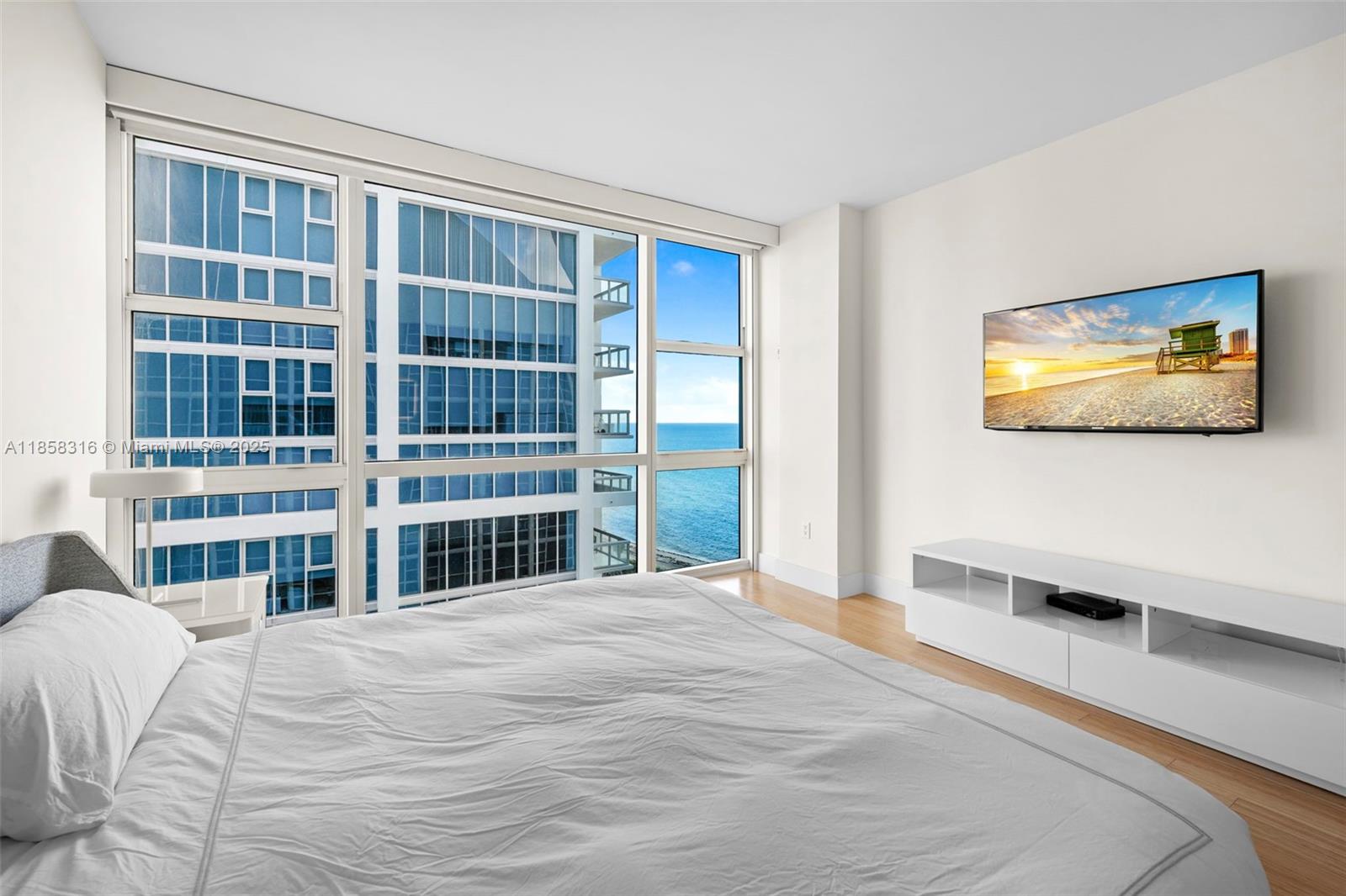 6801 Collins Avenue, Unit DOOR1409 Miami Beach, FL 33141 - Photo 14 of 21 a bedroom with a bed and a large window