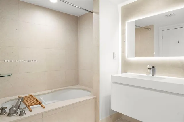 a bathroom with a sink a mirror and shower