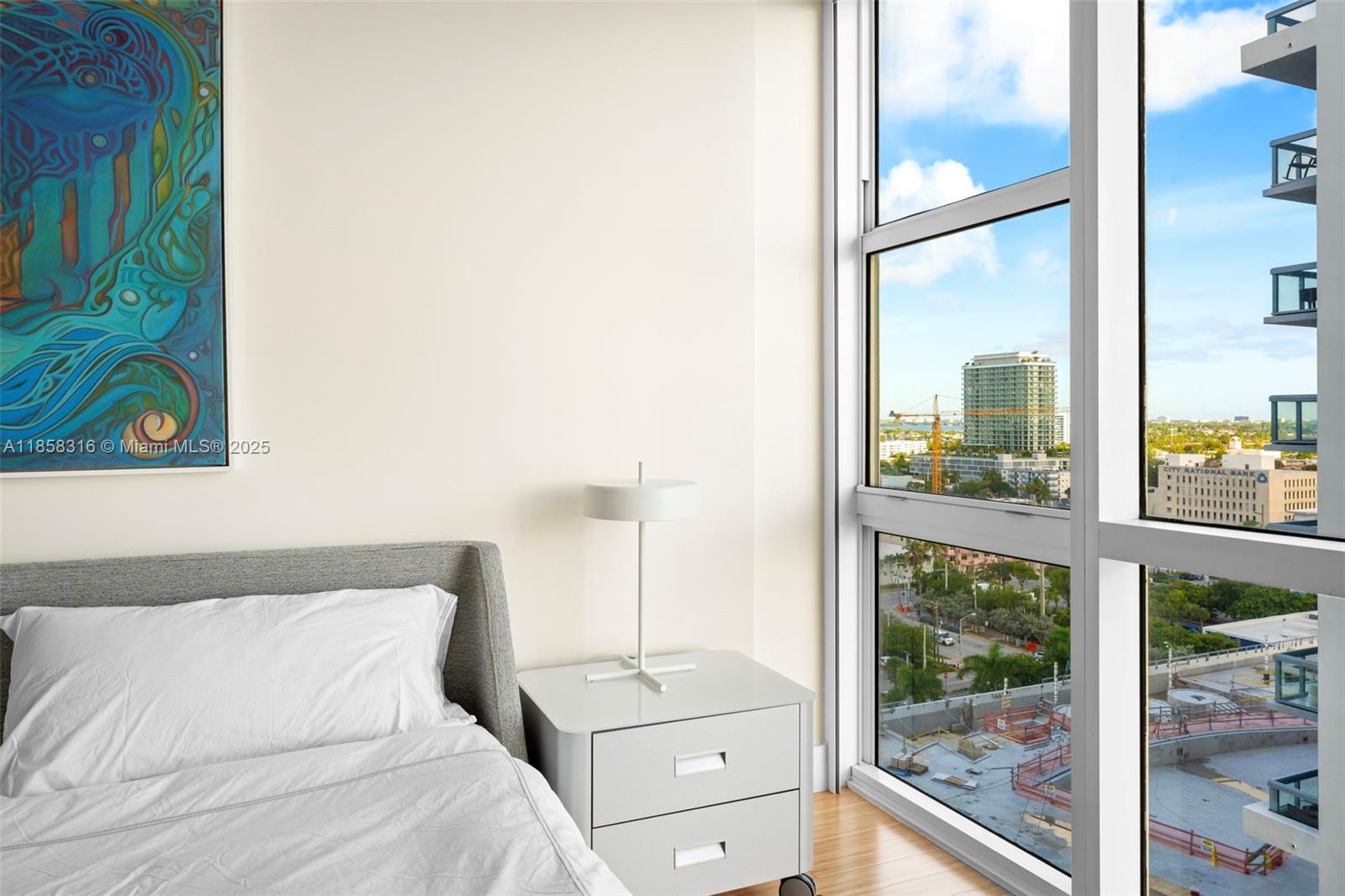 6801 Collins Avenue, Unit DOOR1409 Miami Beach, FL 33141 - Photo 19 of 21 a bedroom with a bed and a window