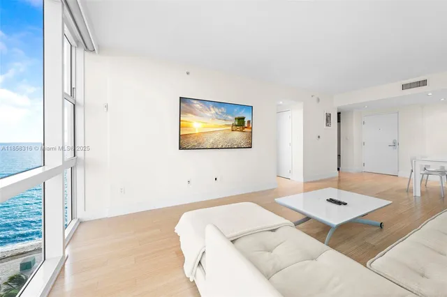 a living room with a bed and a table