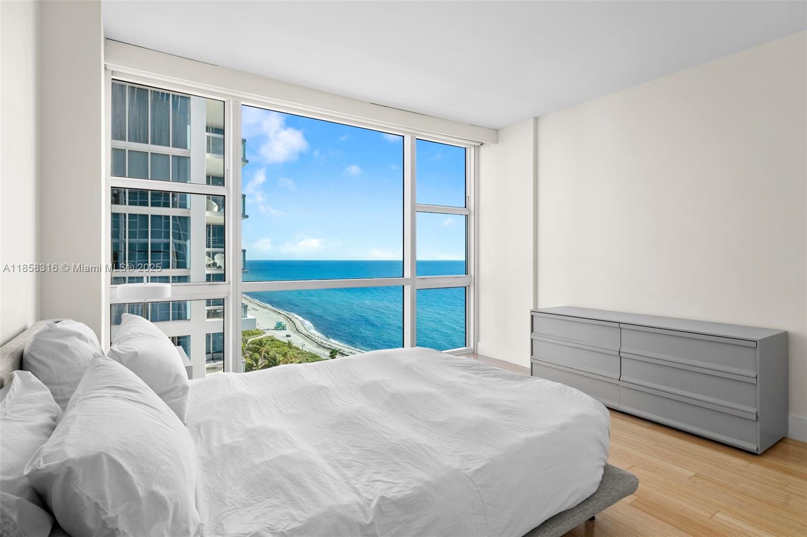 6801 Collins Avenue, Unit DOOR1409 Miami Beach, FL 33141 - Photo 10 of 21 a bedroom with a bed and a window