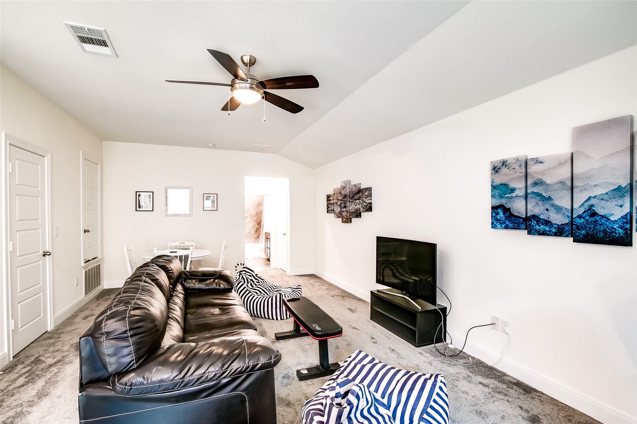 7616 Groundhog Way Austin, TX 78744 - Photo 27 of 34 a living room with furniture a flat screen tv and a fireplace