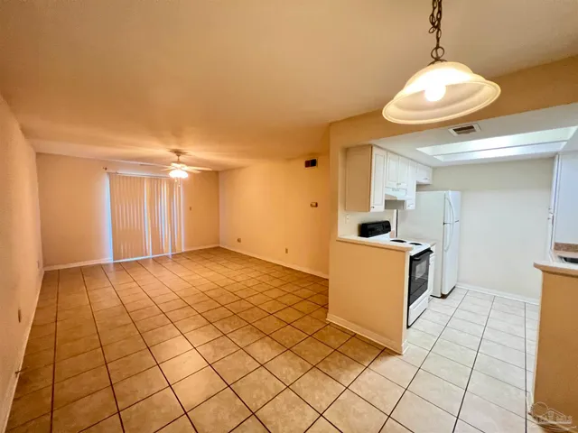 a view of a kitchen with wooden floor and a sink