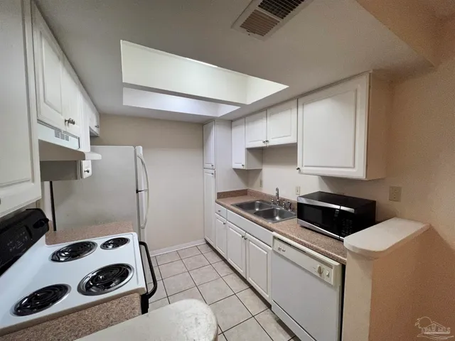 a kitchen with a stove and a refrigerator