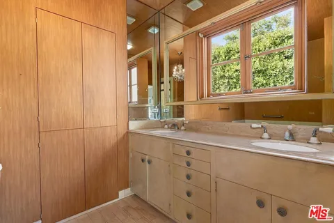 a bathroom with a double vanity sink and a mirror