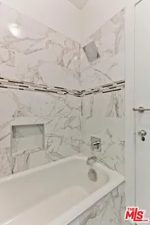 a bathroom with a bathtub and shower