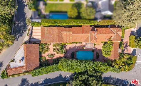 an aerial view of a house with a yard and plants