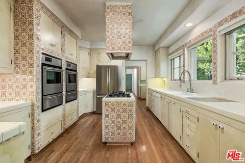 a spacious bathroom with a double vanity sink and a large window