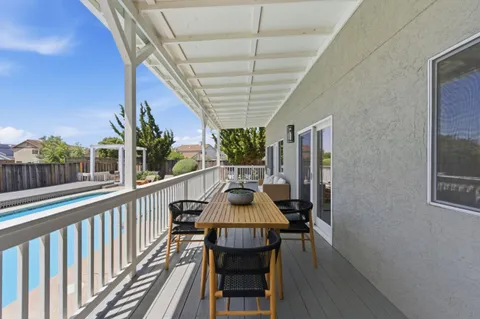 a view of a balcony with furniture