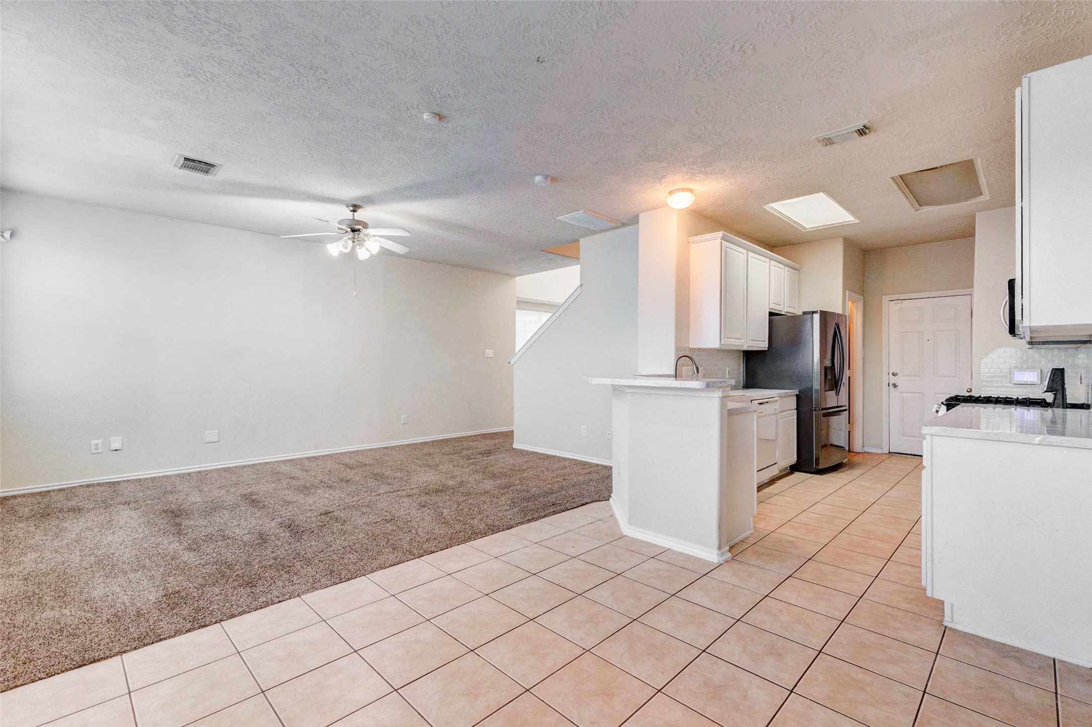 13106 Peppergate Lane Houston, TX 77044 - Photo 5 of 17 a view of kitchen with refrigerator cabinets and microwave