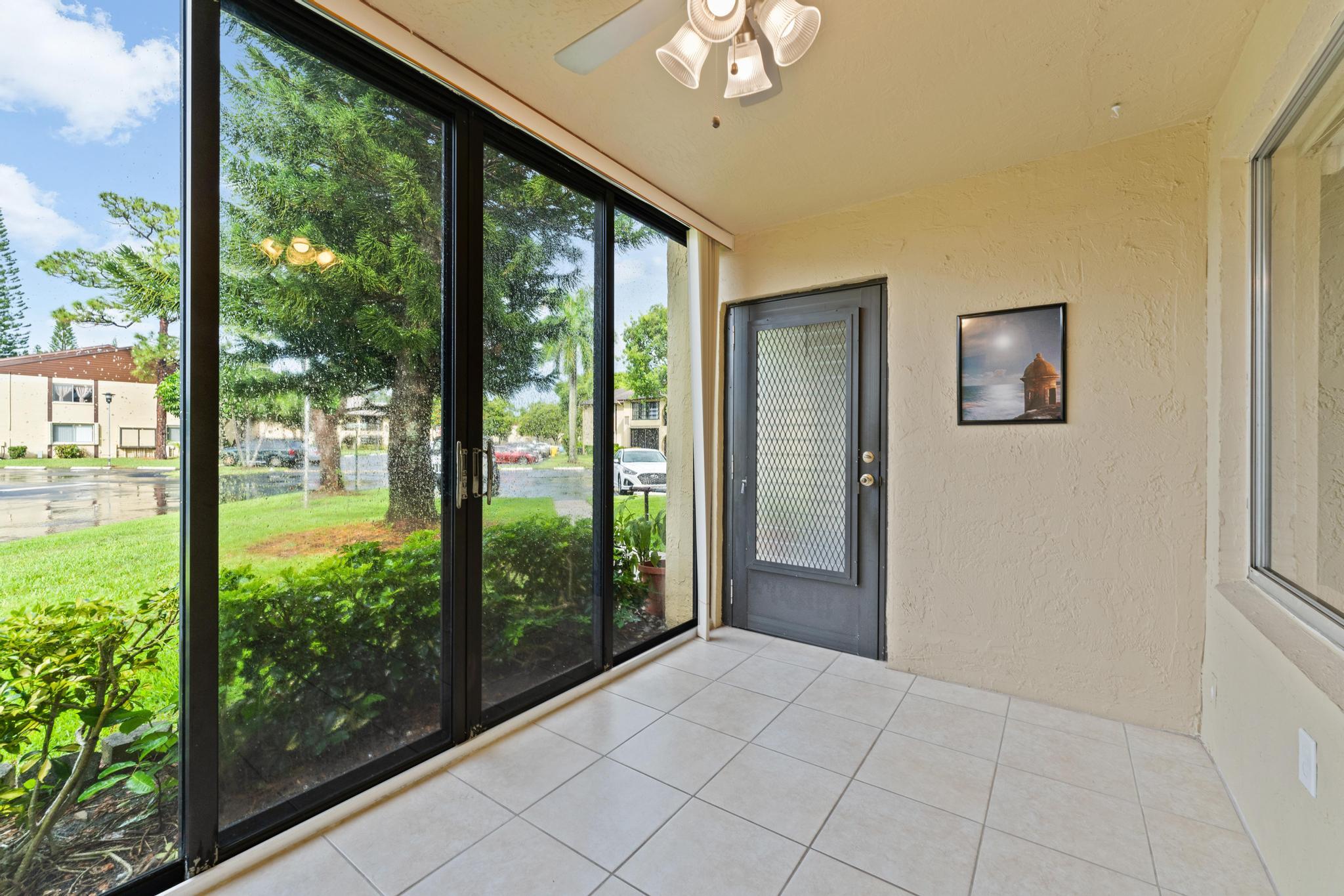 341 Pine Ridge Circle, Unit D1 Greenacres, FL 33463 - Photo 5 of 28 Screened Patio