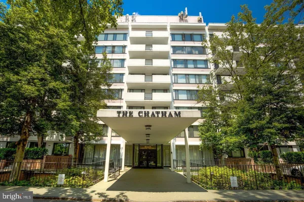 a front view of a building with a garden