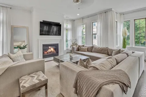 a living room with furniture fireplace and flat screen tv