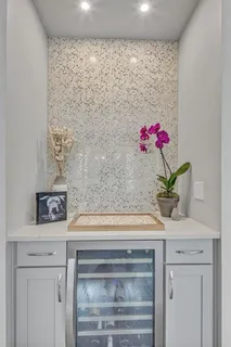 a bathroom with a sink a vanity and a potted plant