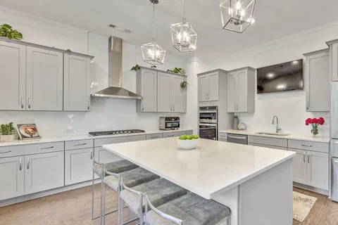 a kitchen with a white center island and cabinets
