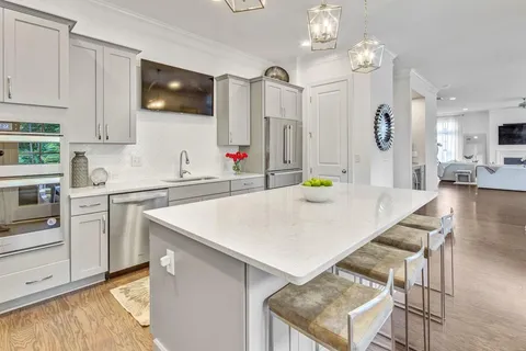 a kitchen with a sink a stove and cabinets