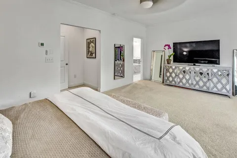 a bedroom with a flat screen tv and a bed