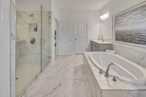 a bathroom with a tub sink and shower