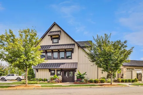a view of a house with a yard and plants