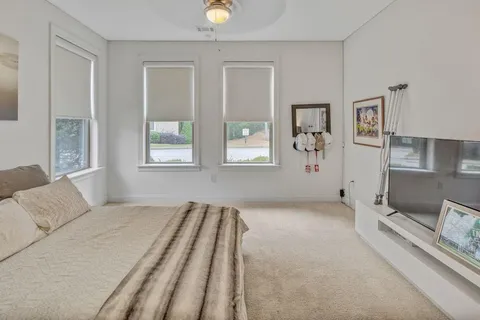 a spacious bedroom with a bed and a couch