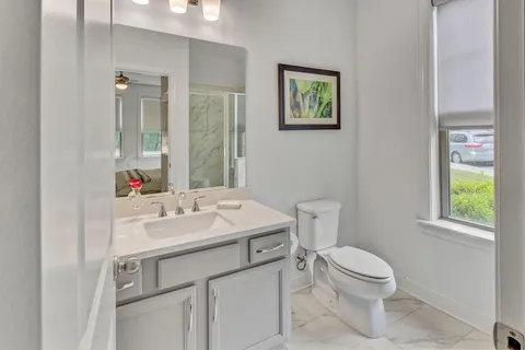 a bathroom with a sink a toilet and mirror
