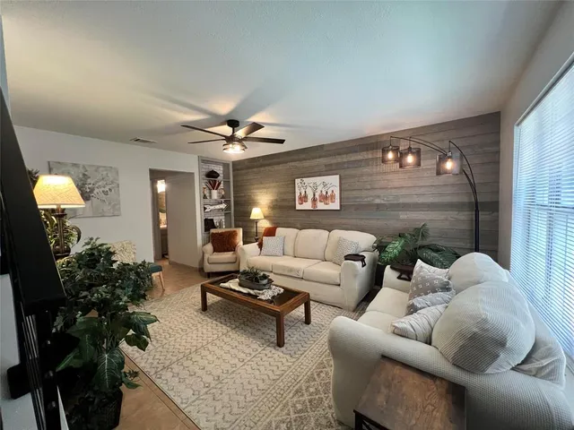 a living room with furniture and a potted plant