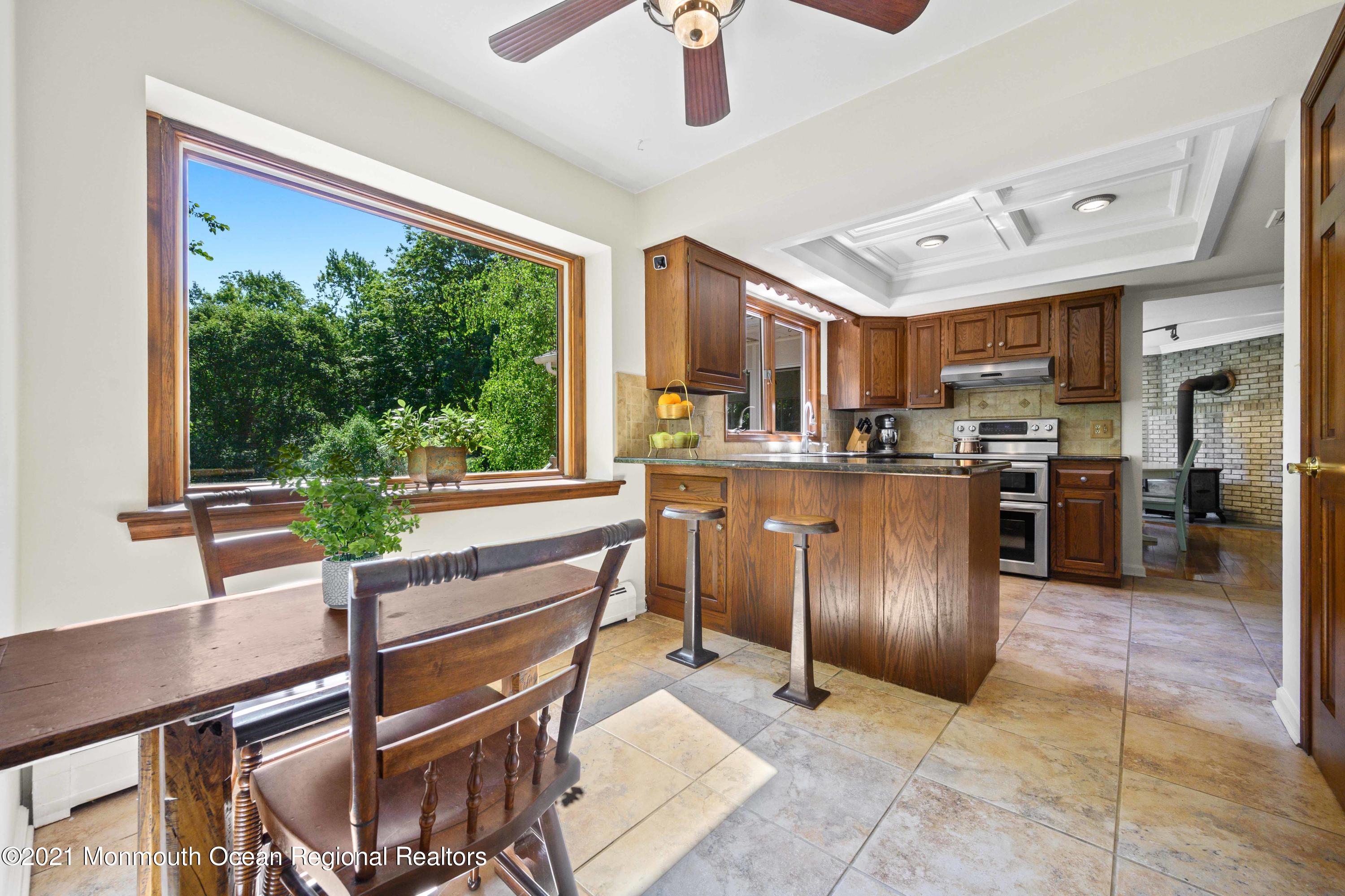 142 Manners Road Flemington, NJ 08822 - Photo 10 of 38 a kitchen with stainless steel appliances granite countertop a stove top oven a sink with dining table and chairs