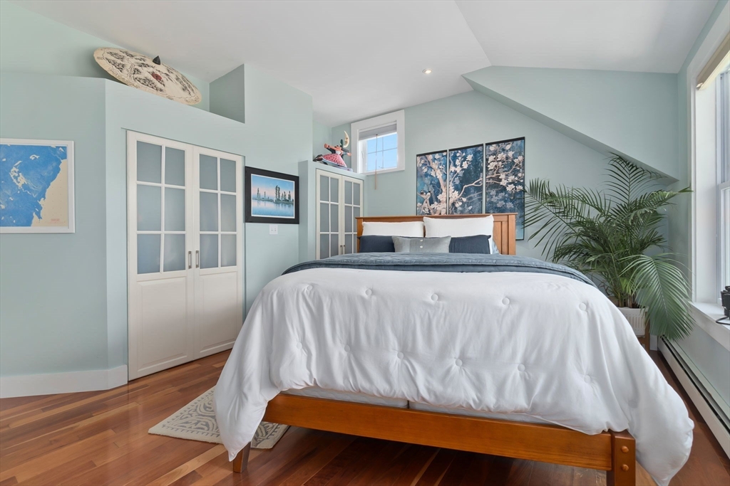 11 Beacon Street Amesbury, MA 01913 - Photo 23 of 42 a bedroom with a bed and wooden floor