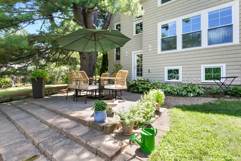 11 Beacon Street Amesbury, MA 01913 - Photo 26 of 42 a view of a patio with table and chairs under an umbrella