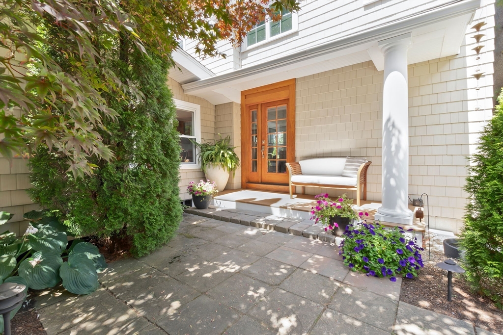 11 Beacon Street Amesbury, MA 01913 - Photo 4 of 42 a front view of a house with a yard and flowers