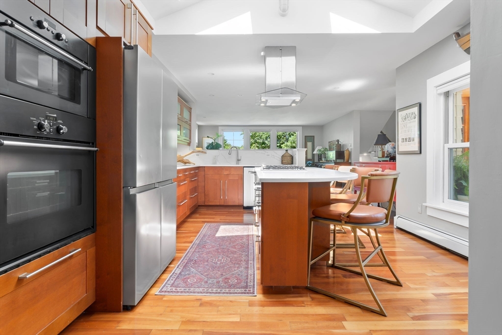 11 Beacon Street Amesbury, MA 01913 - Photo 7 of 42 a view of a dining room with furniture a chandelier and wooden floor