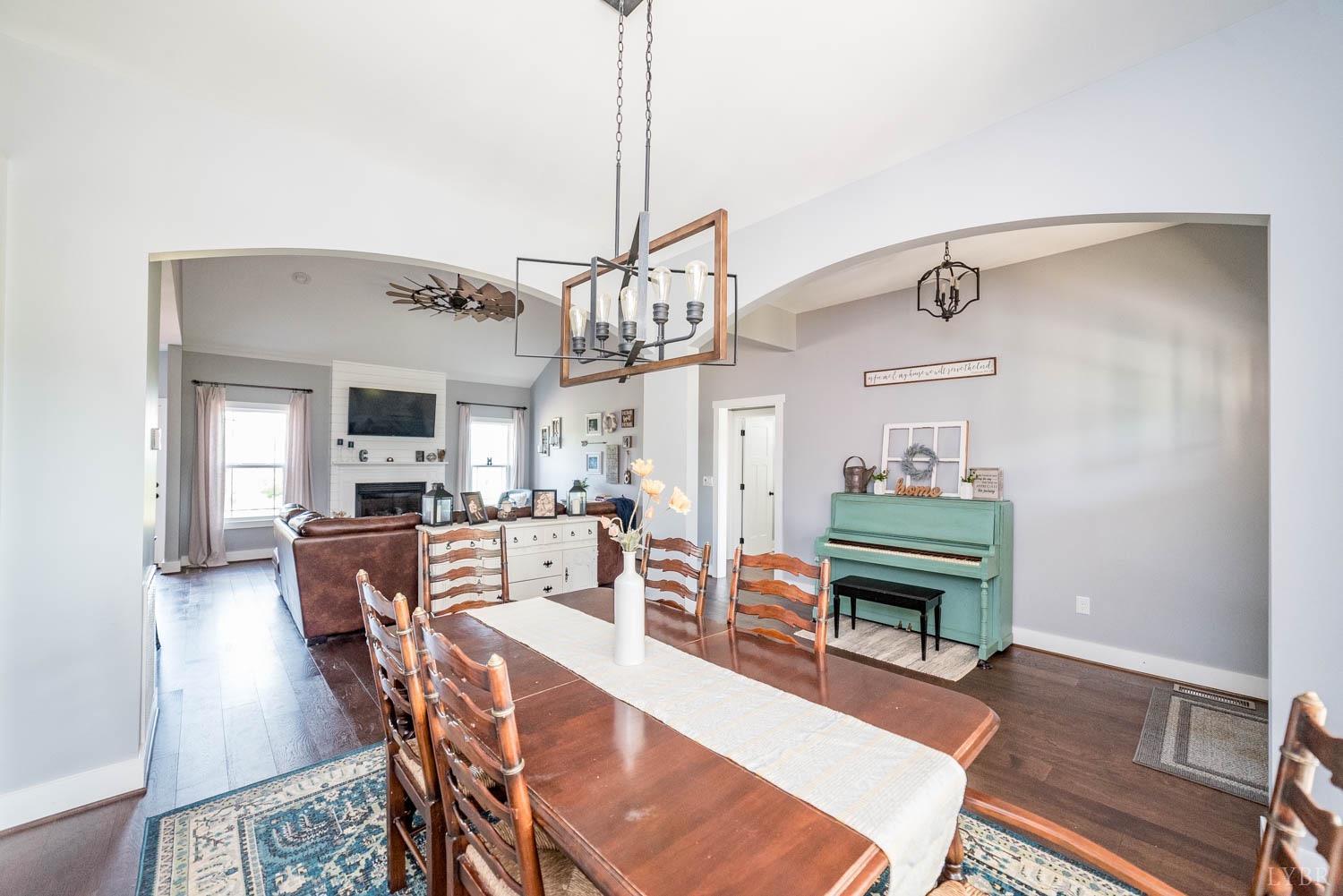5972 Promise Land Road Appomattox, VA 24522 - Photo 22 of 84 a living room with furniture a wooden floor and a chandelier