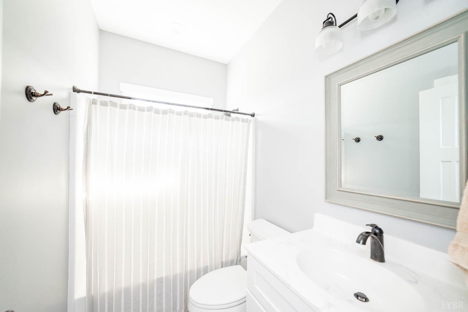 5972 Promise Land Road Appomattox, VA 24522 - Photo 26 of 84 a bathroom with a sink and a mirror