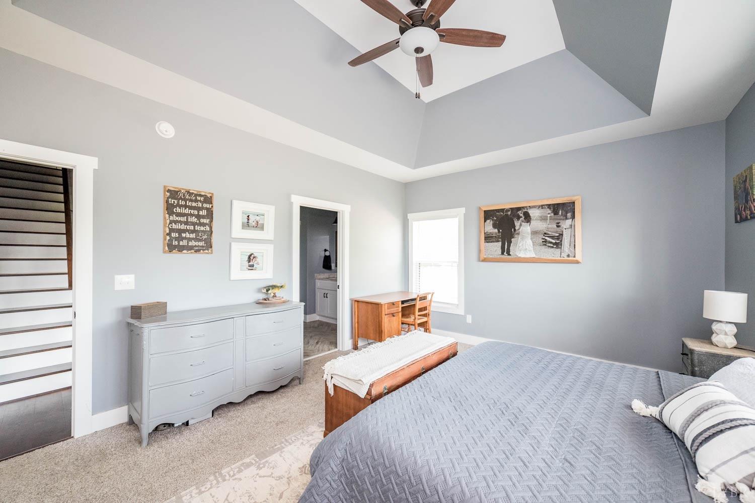 5972 Promise Land Road Appomattox, VA 24522 - Photo 30 of 84 a bedroom with a large bed and a chandelier