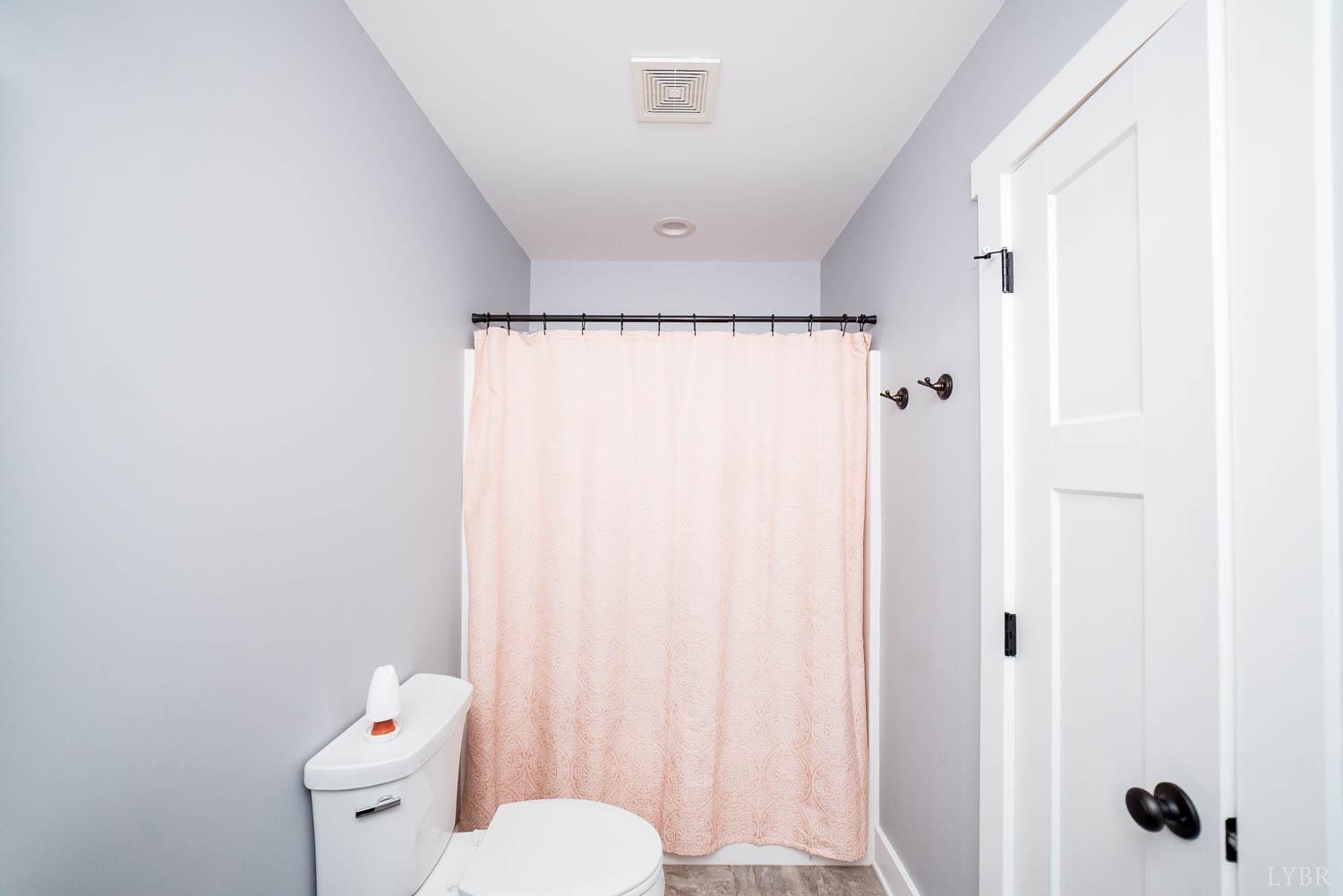 5972 Promise Land Road Appomattox, VA 24522 - Photo 41 of 84 a white toilet sitting next to a shower curtain