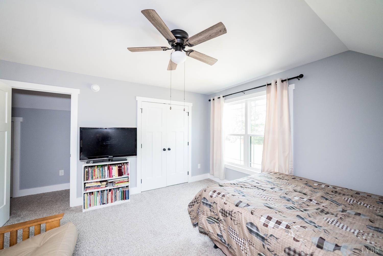 5972 Promise Land Road Appomattox, VA 24522 - Photo 42 of 84 a bedroom with a bed and a flat screen tv