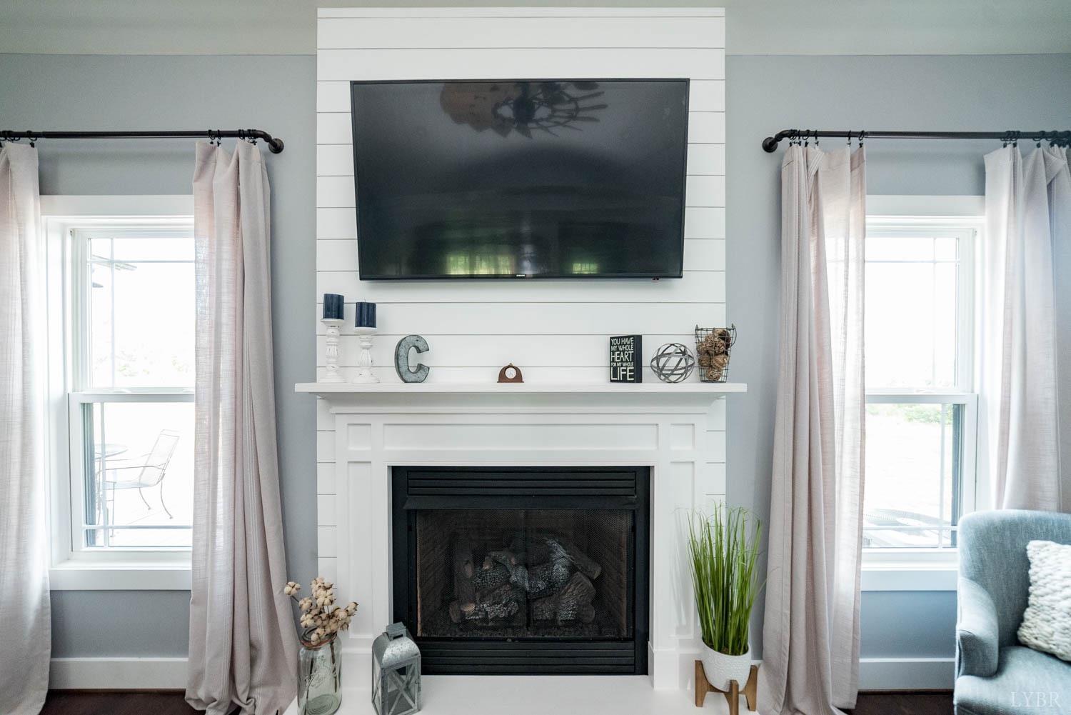 5972 Promise Land Road Appomattox, VA 24522 - Photo 8 of 84 a living room with a fireplace and a flat screen tv