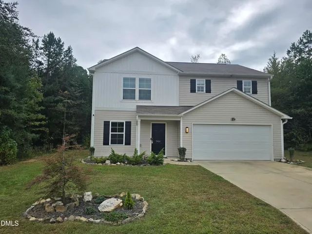 a view of a house with yard and a garden