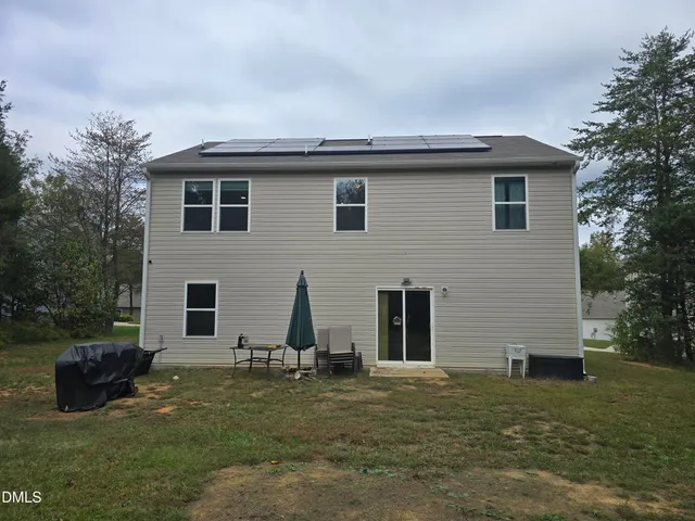 a view of a house with a backyard
