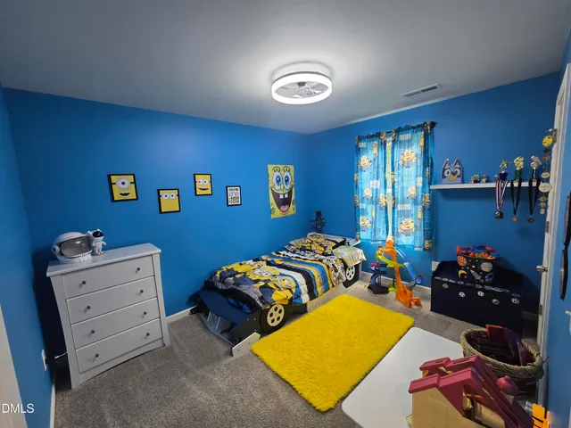 a bed room with bed and a window