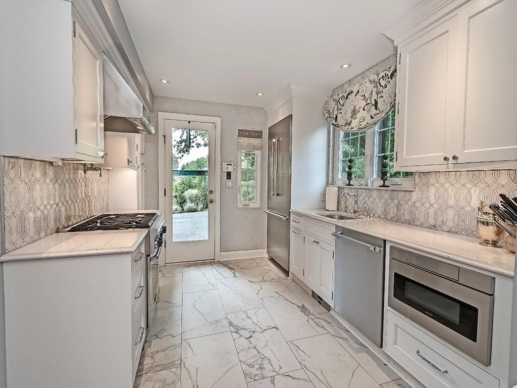 1174 Washington Road Pittsburgh, PA 15228 - Photo 10 of 47 a kitchen with a stove a sink and a refrigerator