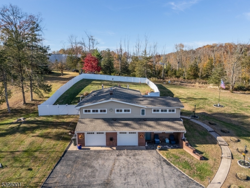 a view of a swimming pool with a yard and a fire pit