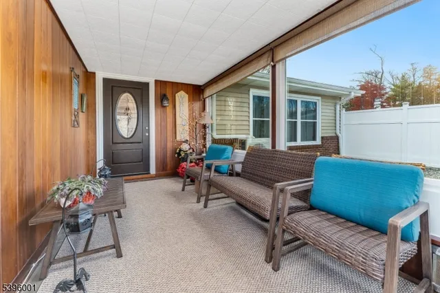 a kitchen with stainless steel appliances granite countertop a refrigerator a sink dishwasher a stove and white cabinets with wooden floor